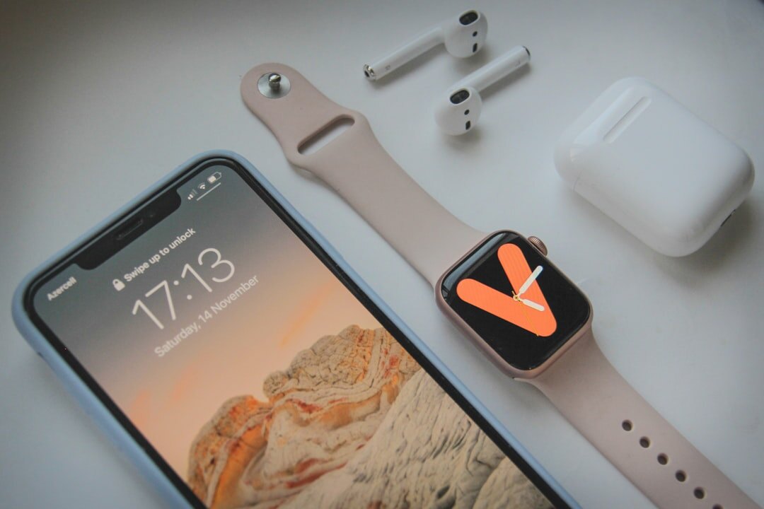 Flat lay of a smartphone, smartwatch, tablet and headphones on a neutral background