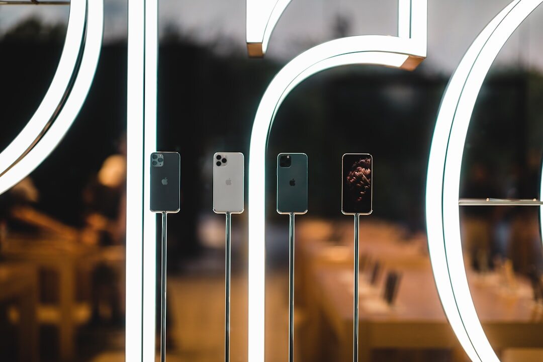 Several smartphones displayed side by side on a shelf
